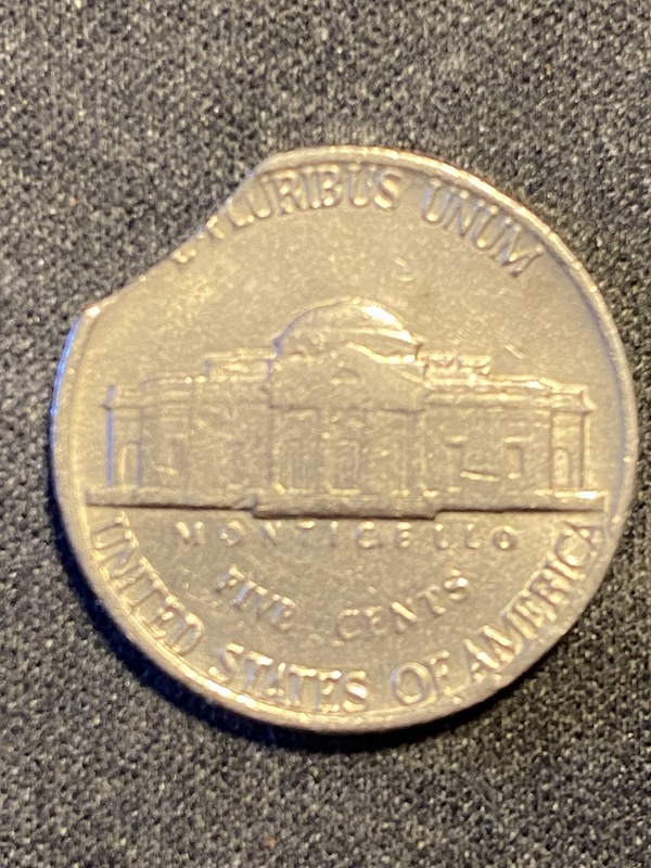 2011 Jefferson nickel clipped planchet error showing a curved notch of missing metal along the coin edge